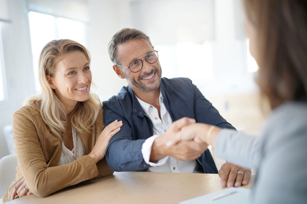 Home investors and real estate clients shake hands